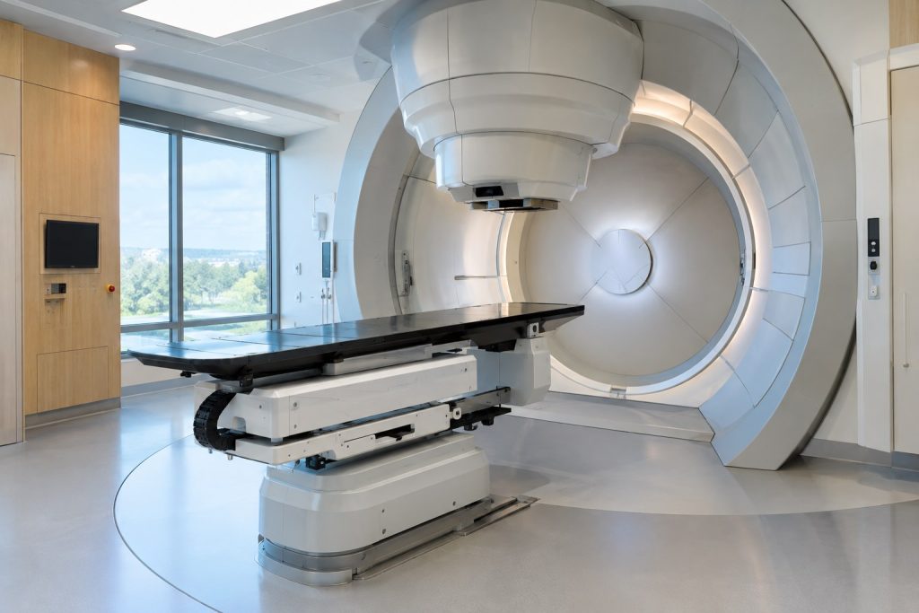 Modern proton beam therapy treatment room and patient positioning couch